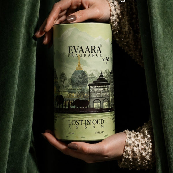 Evaara Fragrance can held by a hand with green fabric background